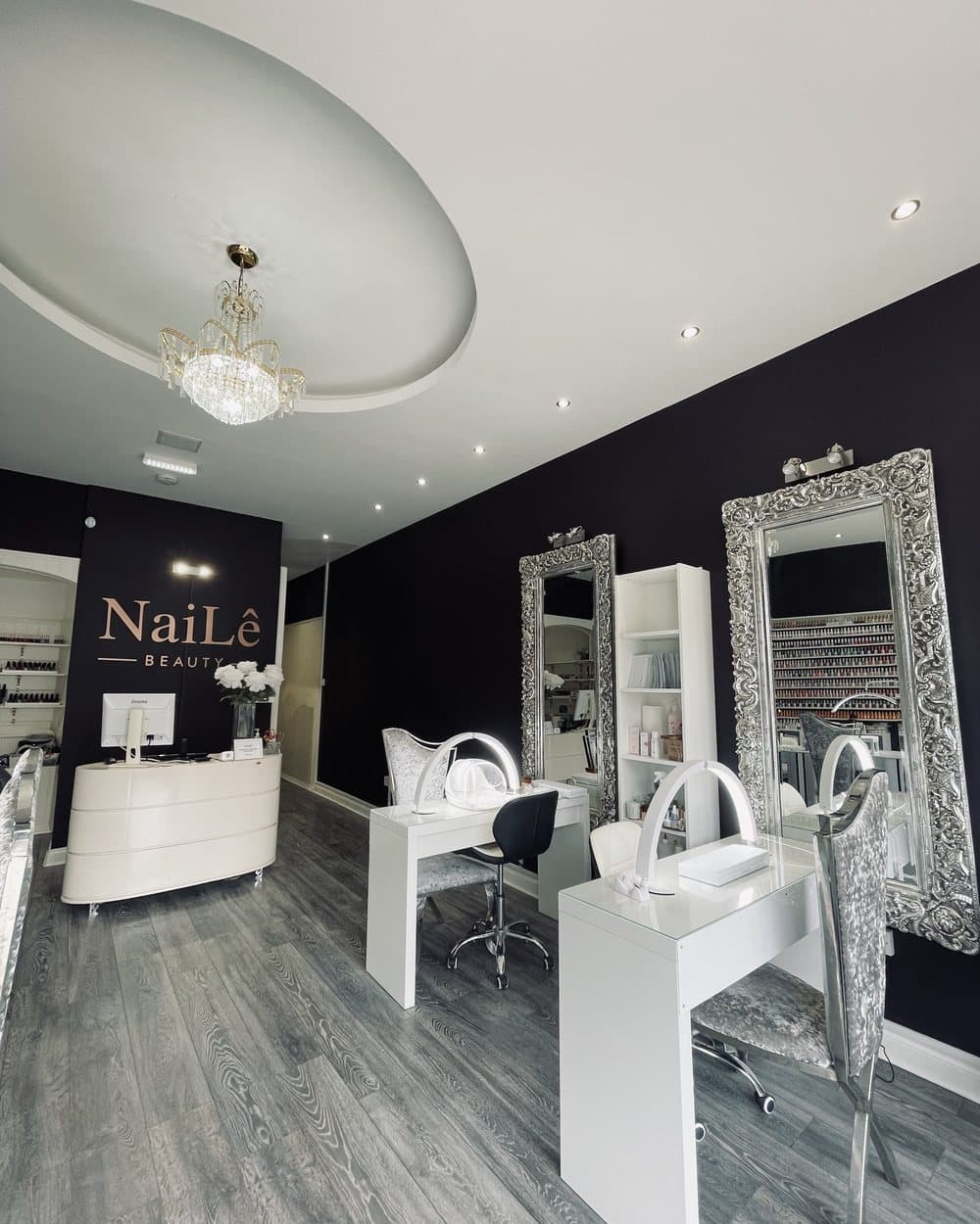 The reception desk, the chandelier and the tall silver mirrors